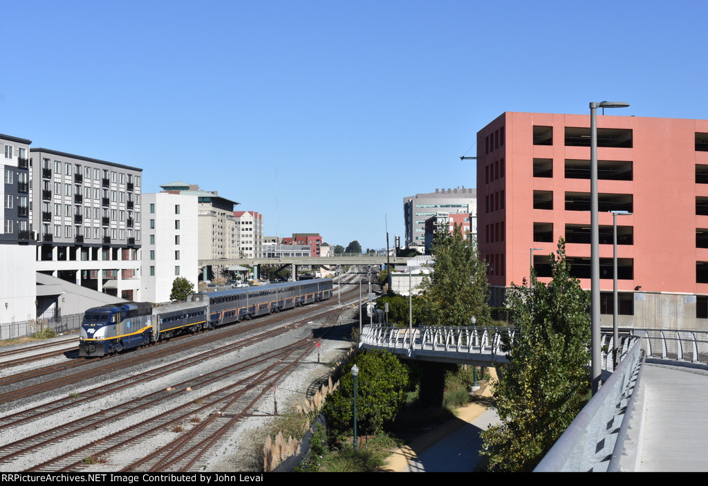 Amtrak Train # 711, with F59PHI # 2005 on the point, has just departed Emeryville Station and is about to run parallel to the Bayfront Bridge pedestrian walkway 